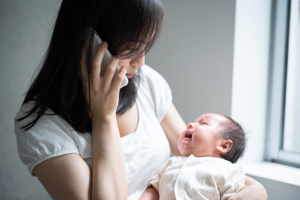 mother calling with crying baby